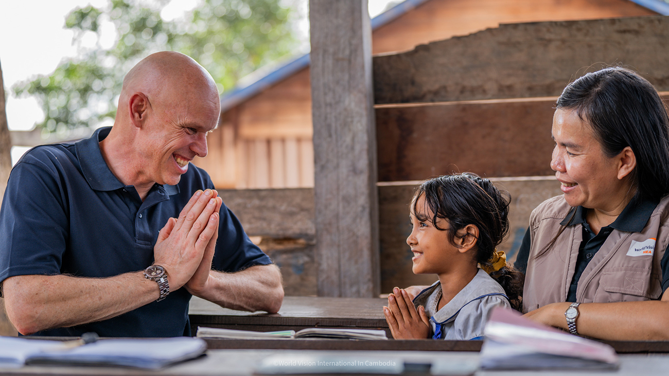 Andrew meets with young student in school In Cambodia